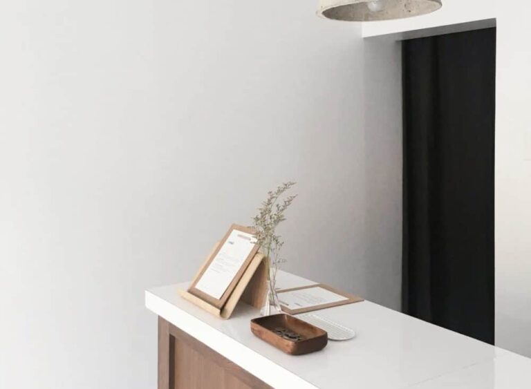 Comptoir blanc épuré avec un cadre photo et une petite plante